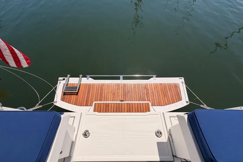 Slide: The Image of Beneteau Oceanis 35.1 yacht stern with wooden deck and American flag, 2018 model. - 21