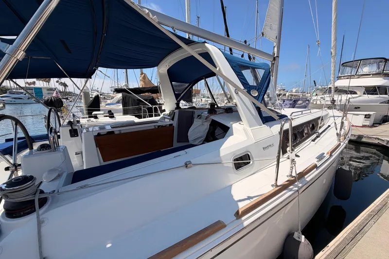 Slide: The Image of 2018 Beneteau Oceanis 35.1 sailboat docked at marina under blue sky. - 9