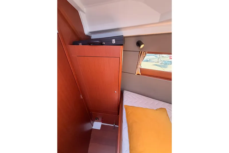 Slide: The Image of Interior cabin of 2018 Beneteau Oceanis 35.1 with wooden cabinetry and cozy bedding. - 63