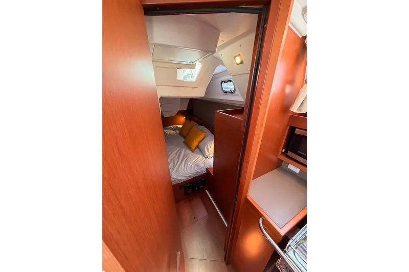 Slide: The Image of Cozy cabin interior of 2018 Beneteau Oceanis 35.1 sailboat with bed and wooden finish. - 44
