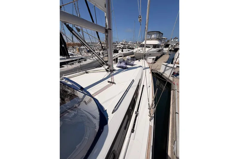 Slide: The Image of 2018 Beneteau Oceanis 35.1 sailboat docked at marina under clear blue sky. - 11