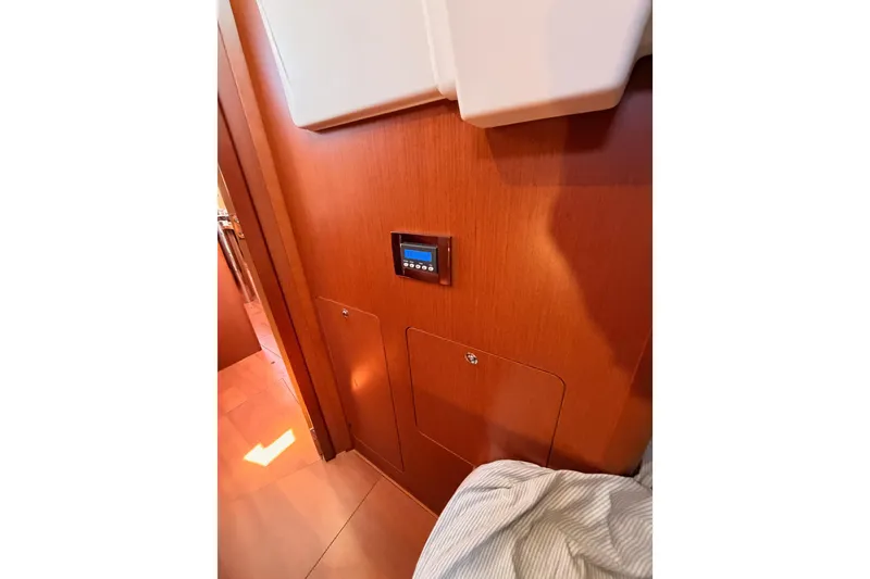 Slide: The Image of Interior of 2018 Beneteau Oceanis 35.1 yacht with wooden paneling and control panel. - 48