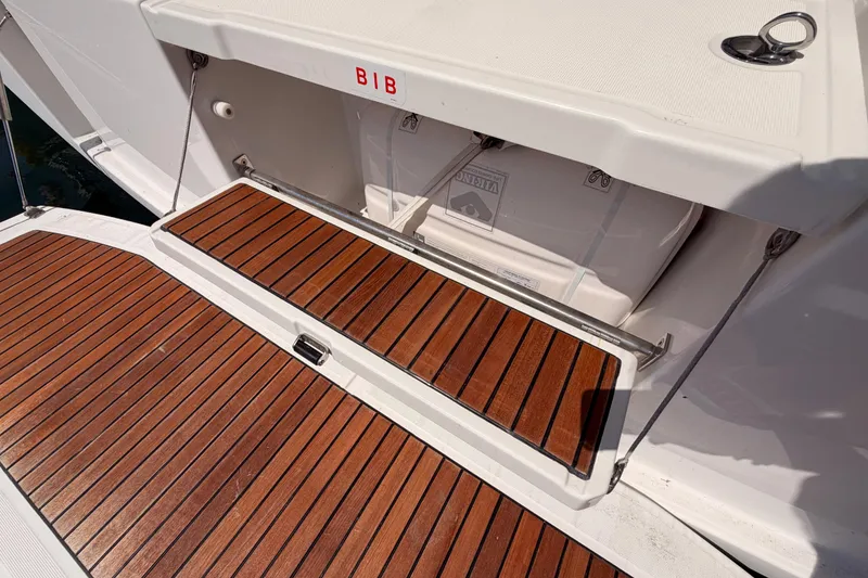 Slide: The Image of Beneteau Oceanis 35.1 (2018) yacht deck with teak flooring and storage compartment. - 23