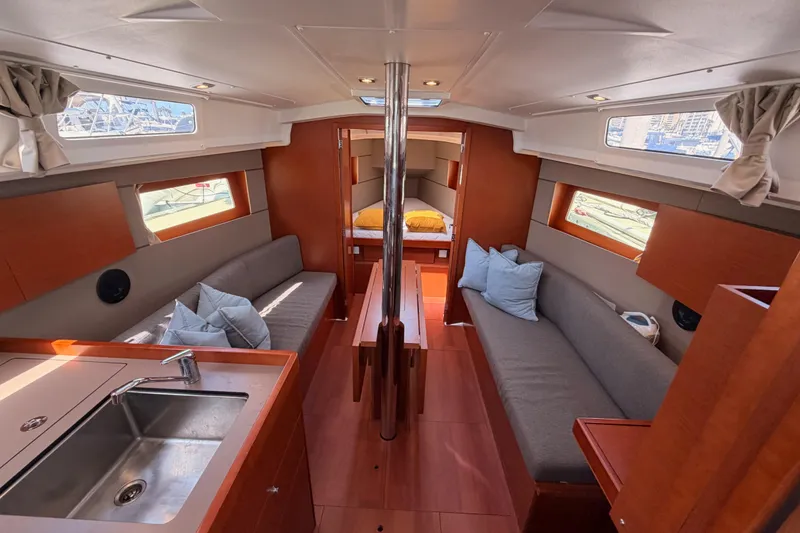 Slide: The Image of Interior of 2018 Beneteau Oceanis 35.1 yacht, featuring cozy seating and modern kitchen area. - 55