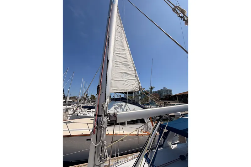 Slide: The Image of Sailboat Beneteau Oceanis 35.1, 2018 model, docked at marina under clear blue sky. - 16