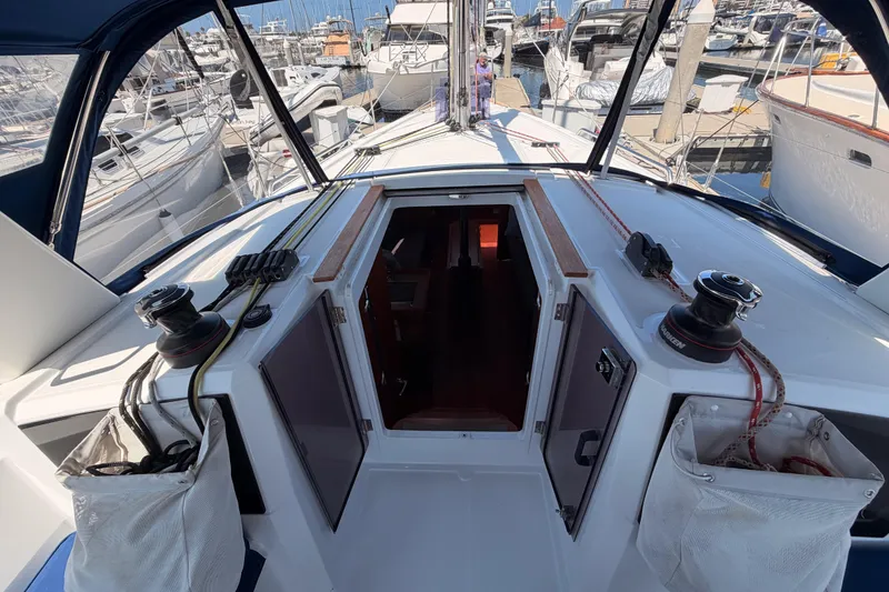 Slide: The Image of Cockpit view of a 2018 Beneteau Oceanis 35.1 sailboat docked at a marina. - 33