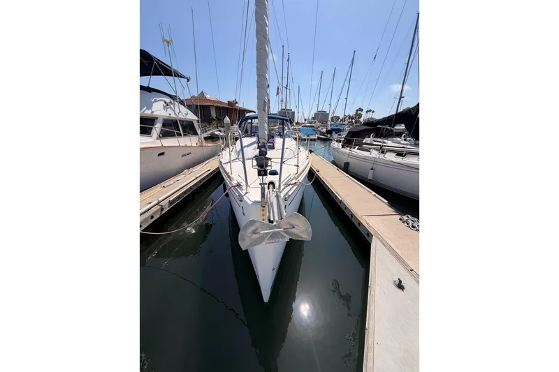 Slide: The Image of 2018 Beneteau Oceanis 35.1 sailboat docked in a marina, surrounded by other boats. - 4