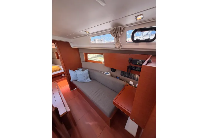 Slide: The Image of Interior of 2018 Beneteau Oceanis 35.1 yacht with cozy seating and navigation equipment. - 57