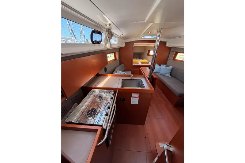 Slide: The Image of Interior of 2018 Beneteau Oceanis 35.1 yacht, featuring kitchen and seating area. - 49