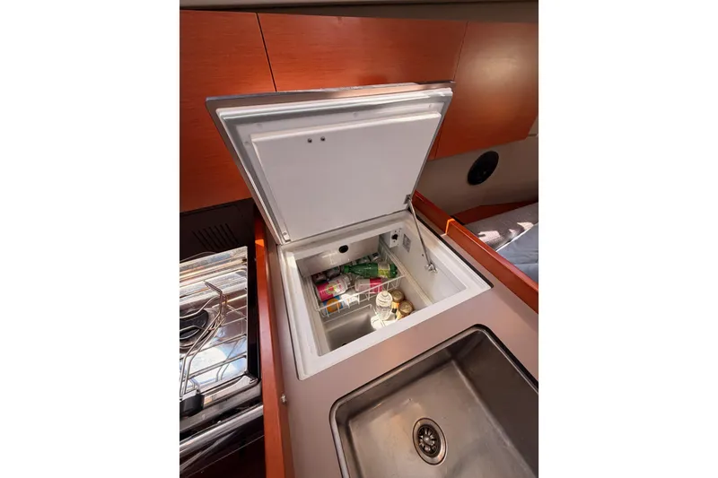 Slide: The Image of 2018 Beneteau Oceanis 35.1 yacht kitchen with open fridge and sink. - 40