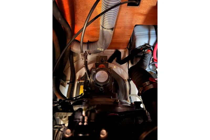 Slide: The Image of Engine compartment of a 2018 Beneteau Oceanis 35.1 sailboat, showing hoses and components. - 71