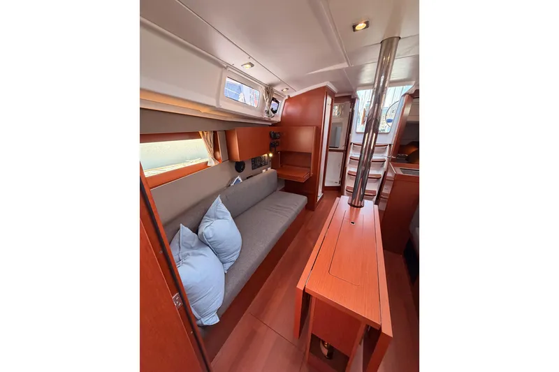 Slide: The Image of Interior of 2018 Beneteau Oceanis 35.1 yacht with cozy seating and wooden finishes. - 66