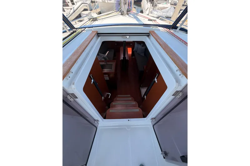 Slide: The Image of 2018 Beneteau Oceanis 35.1 yacht interior view, showcasing cabin entrance and wooden steps. - 35