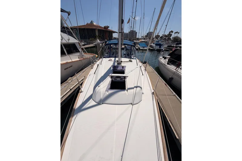 Slide: The Image of 2018 Beneteau Oceanis 35.1 sailboat docked at marina, showcasing sleek deck design. - 14