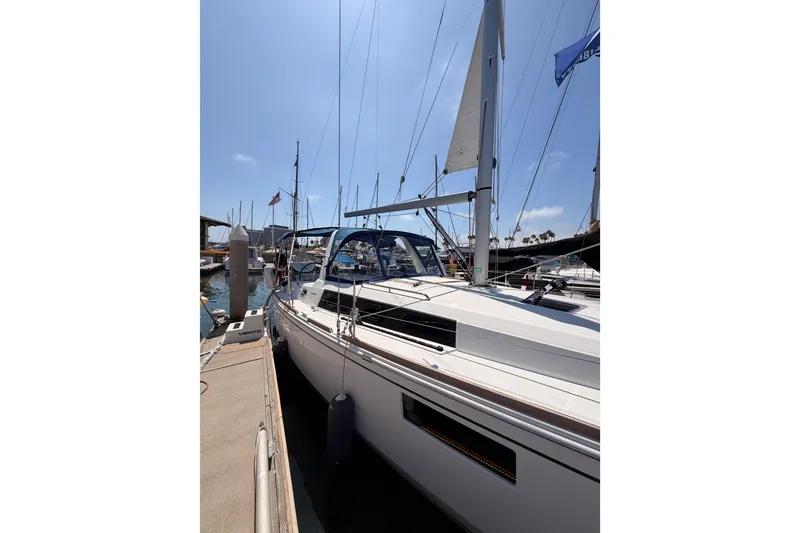 Slide: The Image of 2018 Beneteau Oceanis 35.1 sailboat docked at marina under clear blue sky. - 6