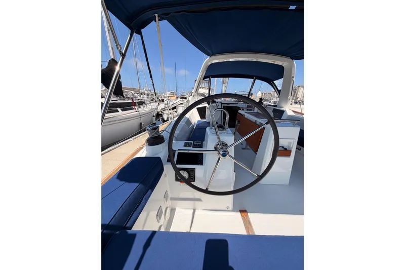 Slide: The Image of Cockpit view of 2018 Beneteau Oceanis 35.1 sailboat with blue seating and steering wheel. - 25