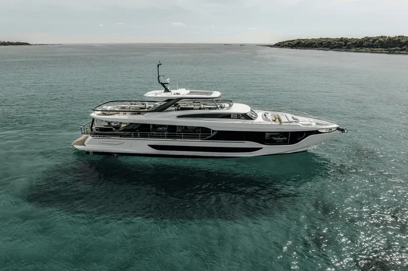 Slide: The Image of Luxurious Azimut Grande 26M yacht from 2027 on calm waters, featuring sleek design and spacious deck. - 25