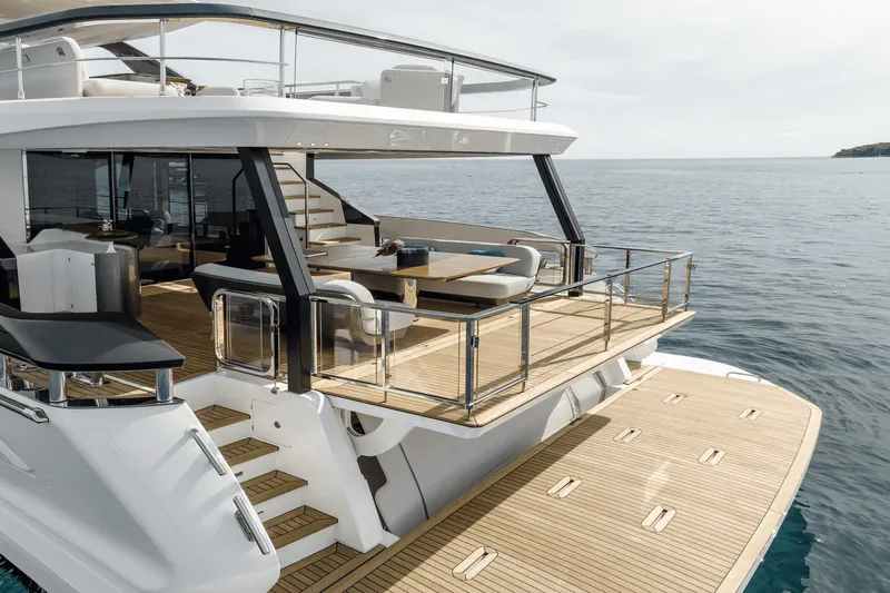 Slide: The Image of The 2027 Azimut Grande 26M features an elegant deck with modern seating and glass railings. - 15