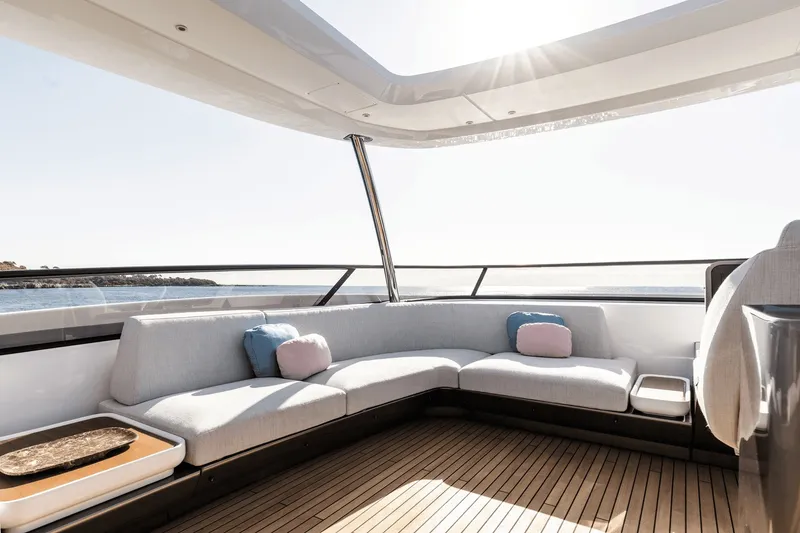 Slide: The Image of The 2027 Azimut Grande 26M features an elegant outdoor seating area with cushions and wooden flooring. - 17