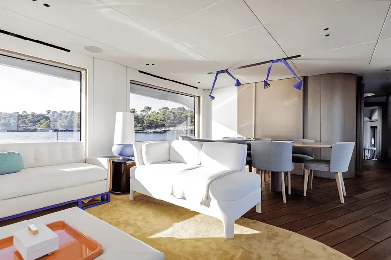 Slide: The Image of Luxurious salon with modern furniture, large windows, and a view of the water. - 46