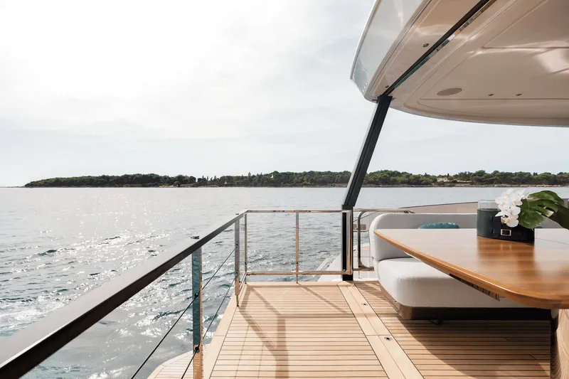 Slide: The Image of The 2027 Azimut Grande 26M features a sleek deck with a table and seating area. - 27
