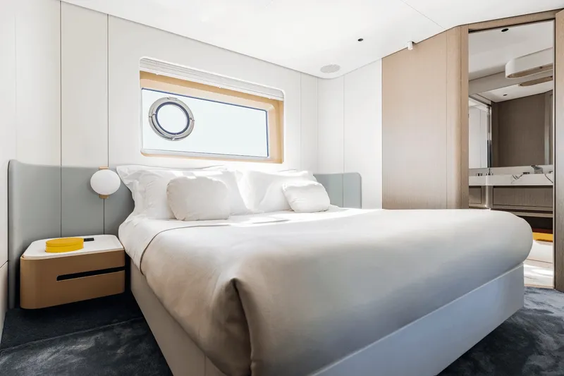 Slide: The Image of Elegant bedroom with large bed, modern design, and window with porthole on an Azimut Grande 26M. - 44