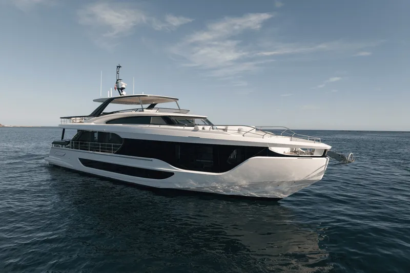 Slide: The Image of The 2027 Azimut Grande 26M is a luxurious yacht with sleek design, floating on calm waters. - 3