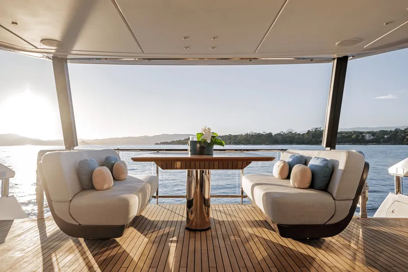 Slide: The Image of The 2027 Azimut Grande 26M features an elegant deck with stylish sofas and a table. - 34