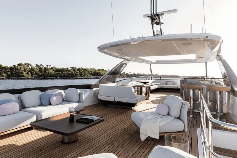 Slide: The Image of The image shows the deck of a luxurious Azimut Grande 26M yacht with elegant seating. - 14