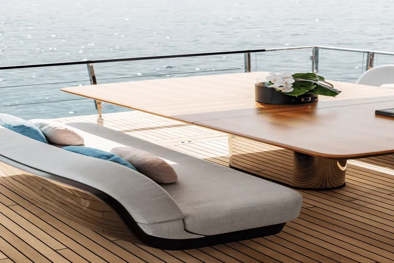 Slide: The Image of Elegant deck with wooden table and curved seating on an Azimut Grande 26M yacht. - 24