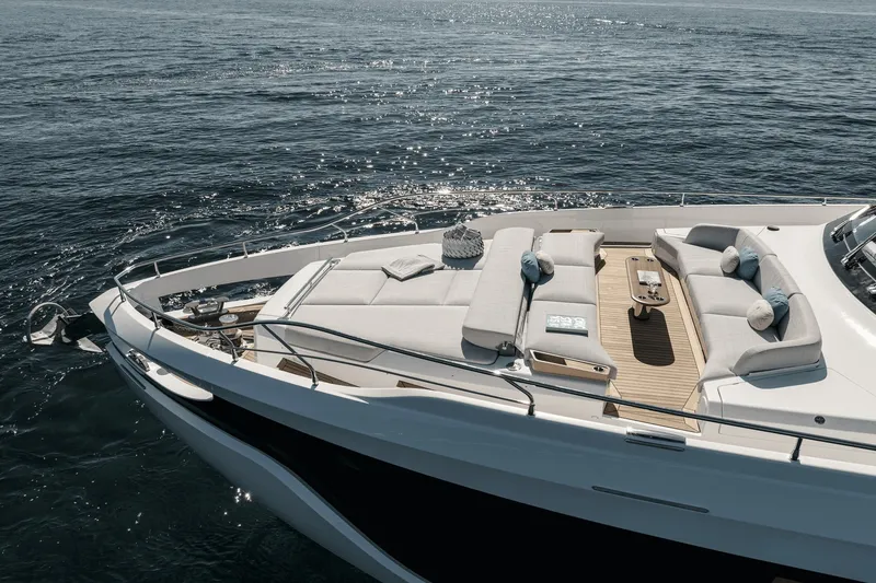 Slide: The Image of The 2027 Azimut Grande 26M features a sleek deck with luxurious seating and cushions. - 35