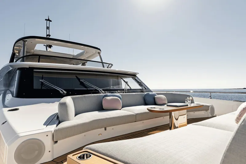 Slide: The Image of The 2027 Azimut Grande 26M features an elegant outdoor deck with stylish seating and a table. - 33