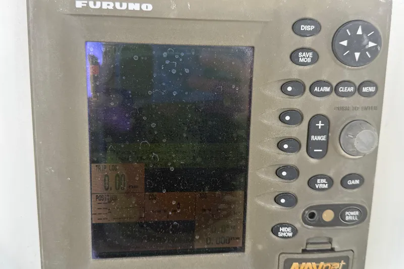 Slide: The Image of A Furuno navigation system with multiple buttons and a screen displaying data. - 30