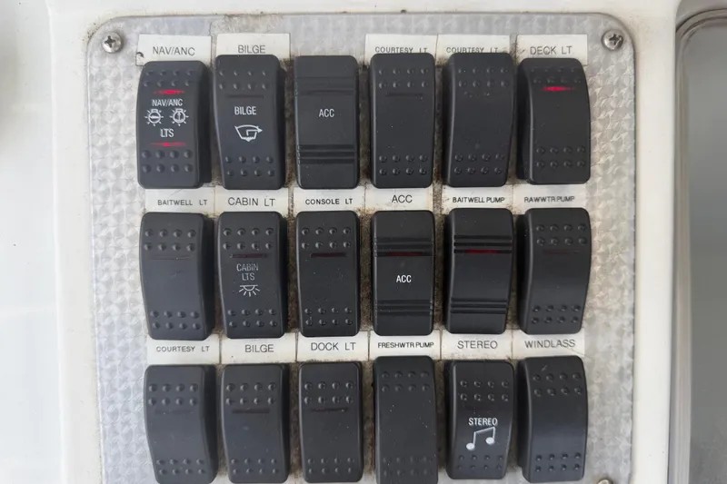 Slide: The Image of Control panel of a 2001 Baja 340 Islander Outboard boat with labeled switches. - 29