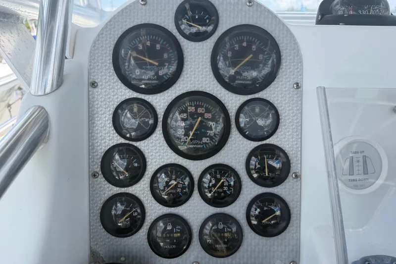 Slide: The Image of Dashboard of a 2001 Baja 340 Islander Outboard with multiple gauges and controls. - 27