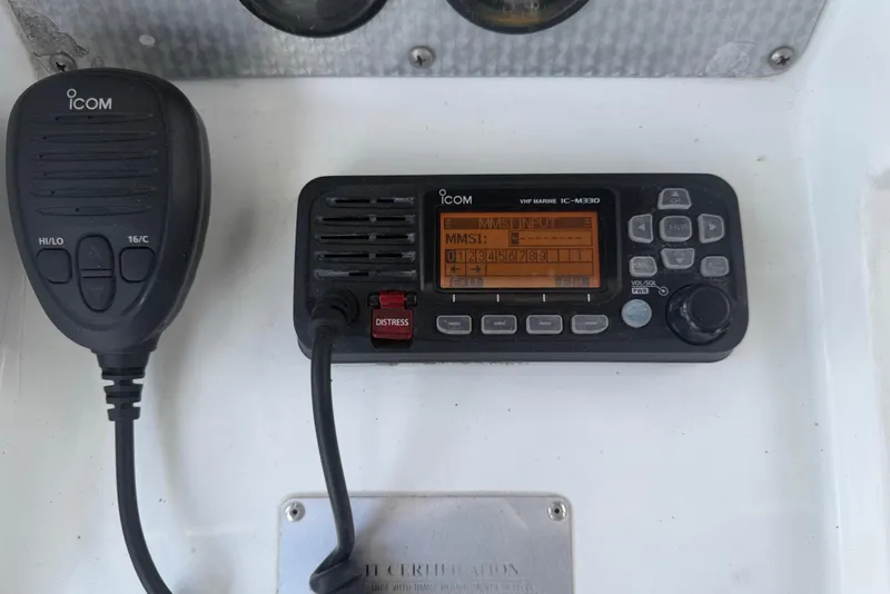 Slide: The Image of An Icom VHF marine radio with a microphone is mounted on board. - 28