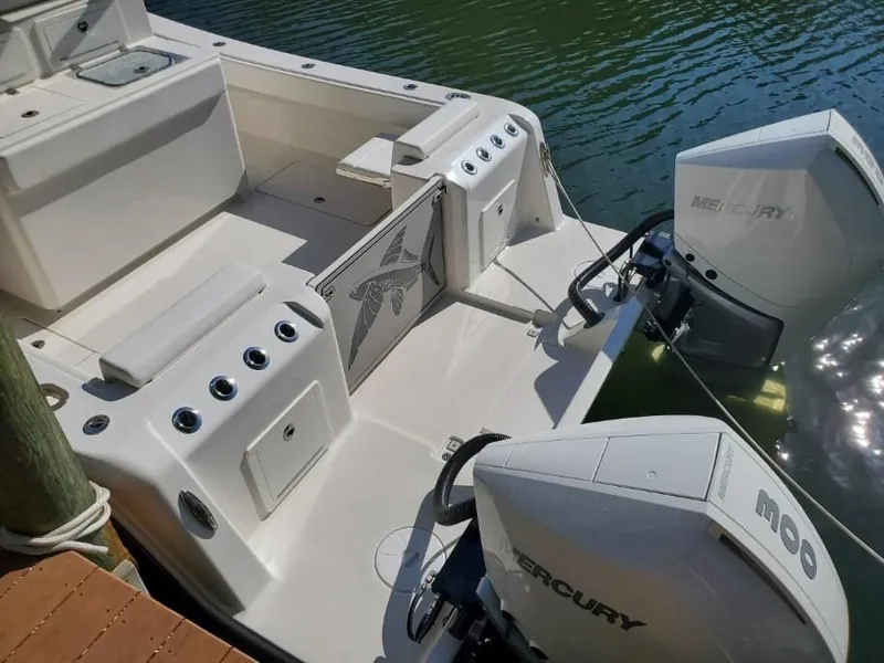 Slide: The Image of The image shows the stern of a 2022 Calcutta 323 boat with two Mercury engines. - 3