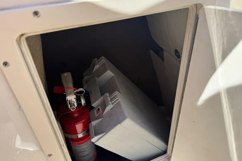 Slide: The Image of Storage compartment in a 2018 Chaparral 19 H2O Ski & Fish boat with fire extinguisher. - 24