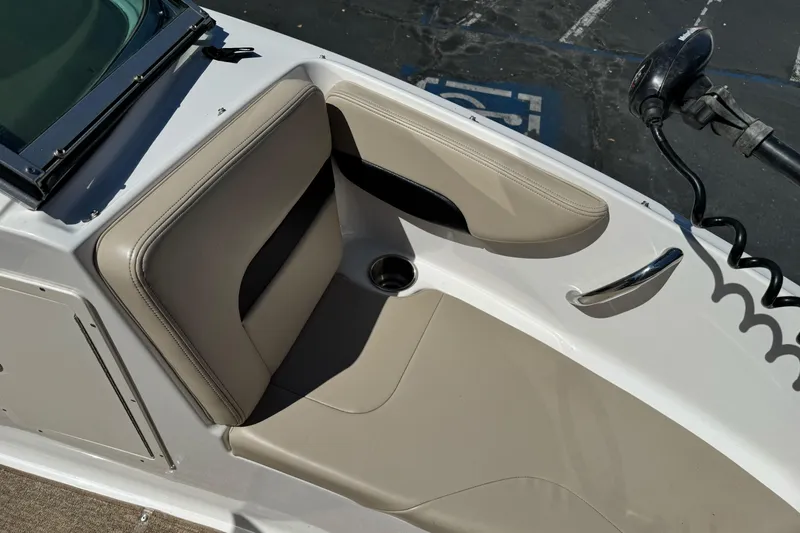 Slide: The Image of 2018 Chaparral 19 H2O Ski & Fish boat interior with beige seating and cup holder. - 21