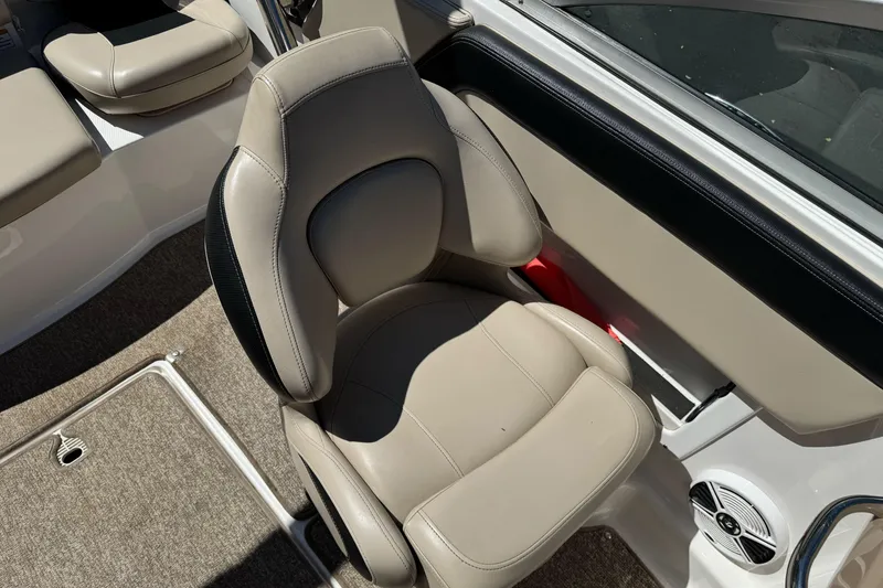 Slide: The Image of 2018 Chaparral 19 H2O Ski & Fish boat interior with beige seating and carpeted flooring. - 16