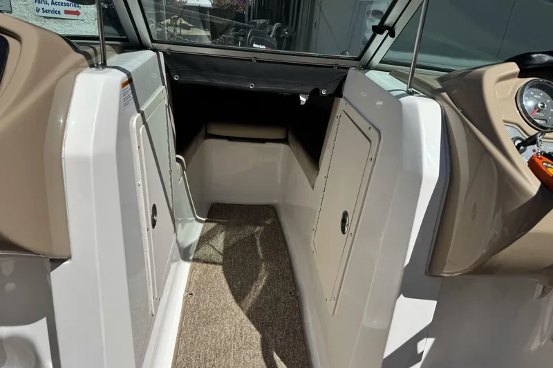 Slide: The Image of 2018 Chaparral 19 H2O Ski & Fish boat interior with storage compartments and dashboard. - 18