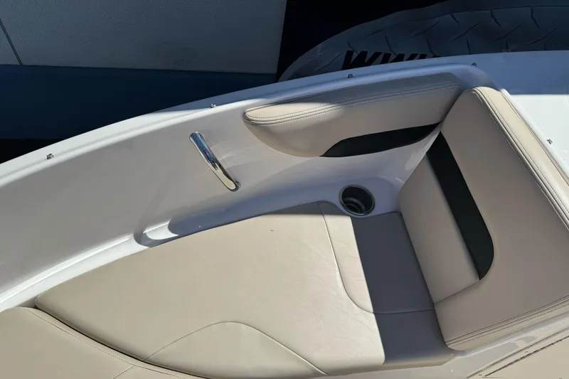 Slide: The Image of 2018 Chaparral 19 H2O Ski & Fish boat interior with beige seating and chrome handle. - 22