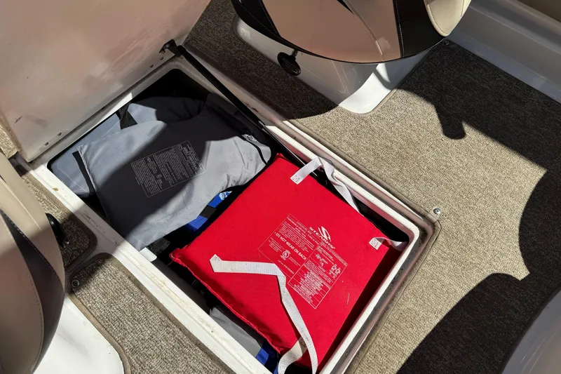 Slide: The Image of Storage compartment in 2018 Chaparral 19 H2O Ski & Fish boat with life jackets. - 25