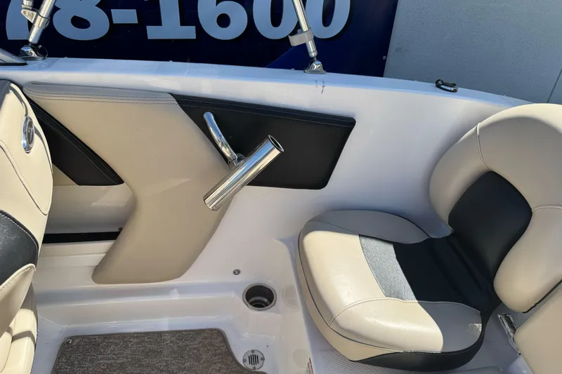 Slide: The Image of Interior of 2018 Chaparral 19 H2O Ski & Fish boat, featuring beige and black seating. - 26