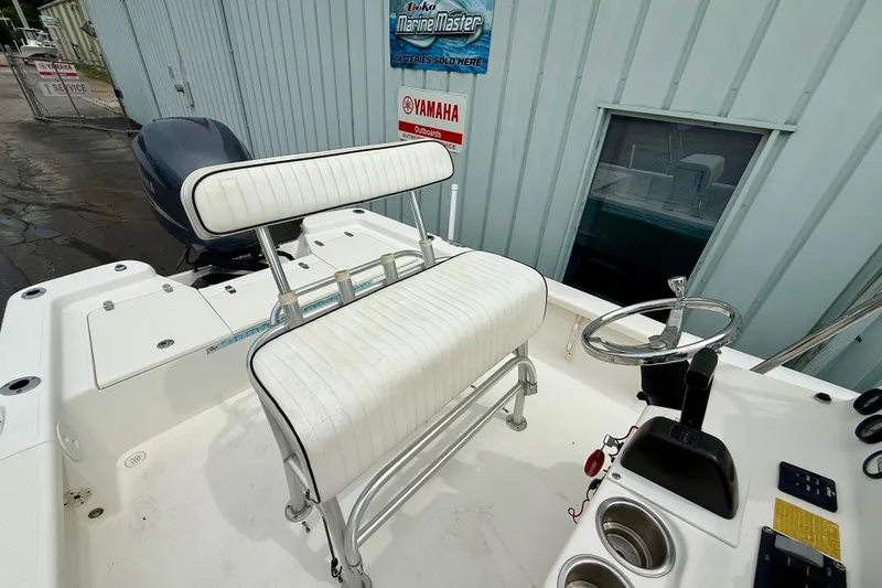 Slide: The Image of 2005 BlackJack 224 boat interior with steering wheel and seating, near Yamaha service sign. - 9