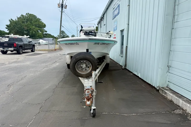 Slide: The Image of 2005 BlackJack 224 boat on trailer beside a building, ready for transport. - 4