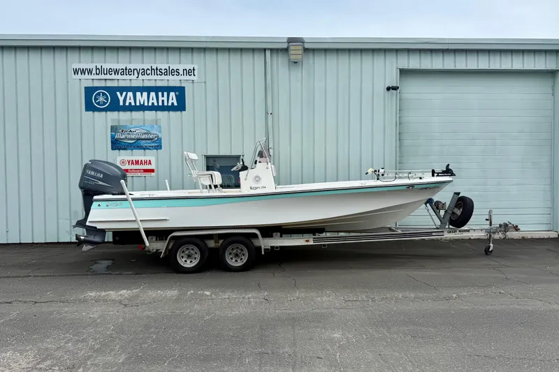 Slide: The Image of 2005 BlackJack 224 boat on trailer outside Yamaha dealership. - 1