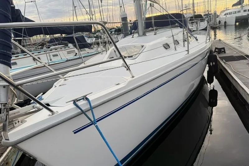 Slide: The Image of 2002 Catalina 320 sailboat docked at marina during sunset. - 1
