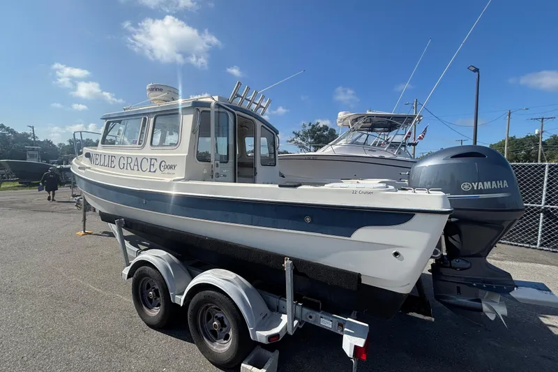 Slide: The Image of 2013 C-Dory 22' Cruiser boat on trailer with Yamaha outboard motor. - 2