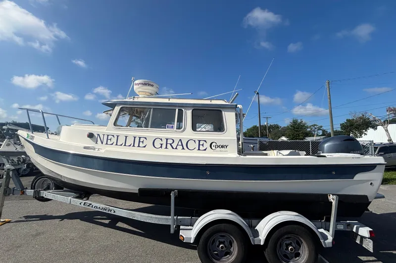 Slide: The Image of 2013 C-Dory 22' Cruiser boat on trailer under blue sky. - 1